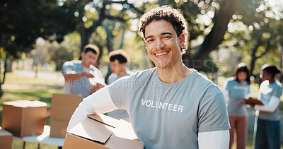 Buy stock photo Volunteer, portrait and man with box outdoor for outreach program, community service and welfare. Happy, park and person with package for food drive, donation and charity event for ngo campaign