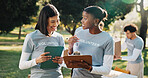 Volunteer, tablet and women with clipboard for talking, planning and grocery list for donation. Outdoor, team and people with tech, checklist and inventory for food drive, aid and charity outreach