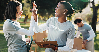 Buy stock photo Volunteer, teamwork and women outdoor for high five, clipboard and grocery quota for donation. Park, happy and people celebrate for food drive, collection success and welfare for charity outreach