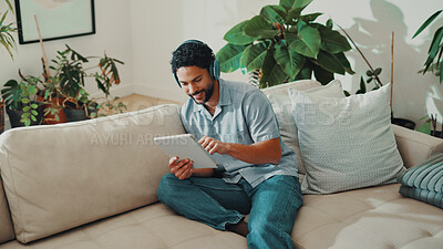 Buy stock photo Man, happy and headphones or tablet on home sofa for streaming music, podcast or online subscription. Smile, audio playlist and male person relax on couch with mobile app, technology and sound