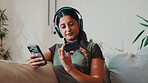 Woman, phone and credit card in home with headphones,  check CVV and payment for music subscription. Person, audio tech and mobile banking on sofa with website, EFT or purchase for streaming service.