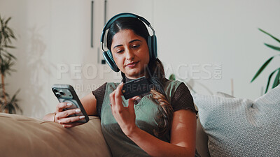 Buy stock photo Woman, phone and credit card in home with headphones,  check CVV and payment for music subscription. Person, audio tech and mobile banking on sofa with website, EFT or purchase for streaming service.