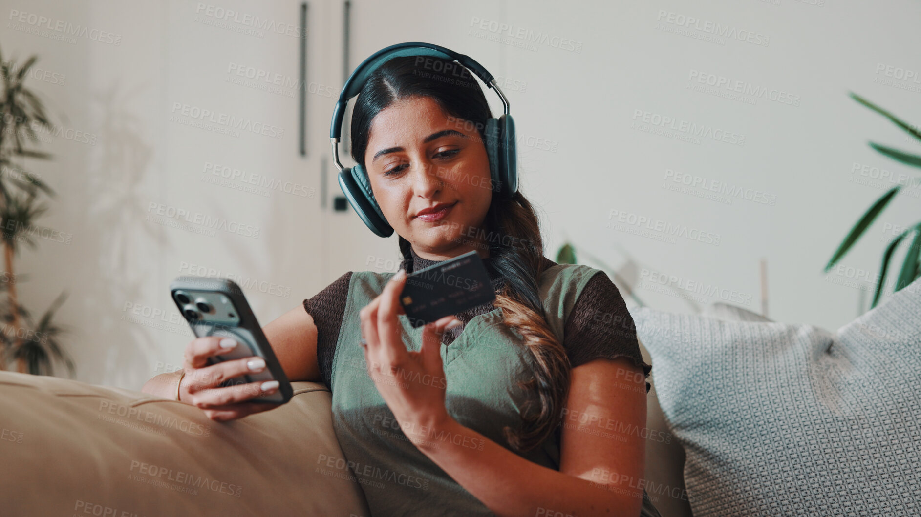 Buy stock photo Woman, phone and credit card in home with headphones,  check CVV and payment for music subscription. Person, audio tech and mobile banking on sofa with website, EFT or purchase for streaming service.
