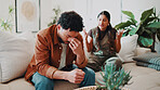 Man, stress and couple with conflict in home, fight or infidelity with frustrated person and partner. Upset, argument and cheating betrayal with people in living room, relationship crisis or affair