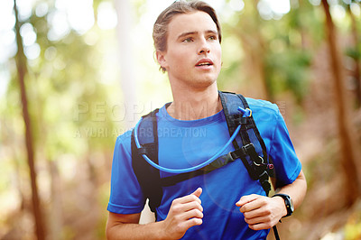 Buy stock photo Running, fitness and man in forest, training and wellness with challenge, cardio and workout. Healthy person, outdoor and athlete in woods, practice for marathon and endurance with exercise or runner