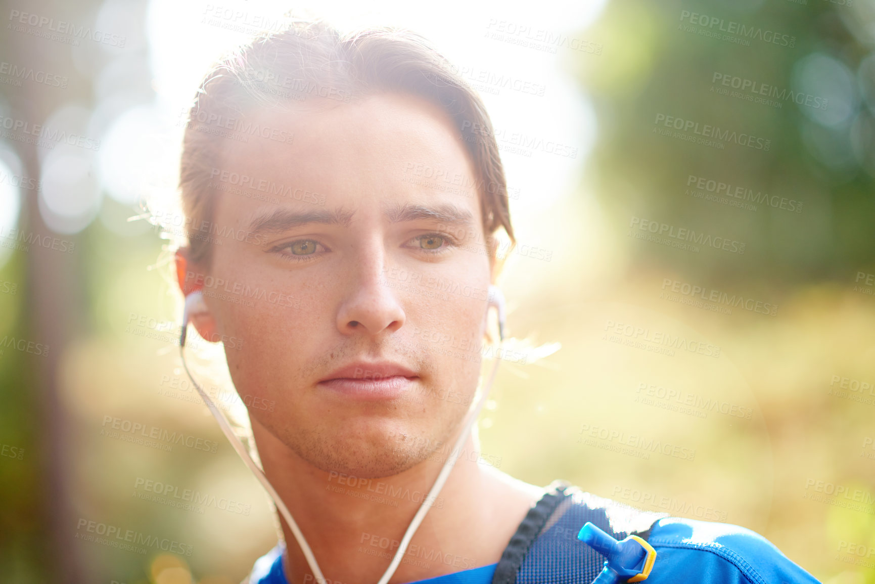 Buy stock photo Man, runner and earphones for training in forest, outdoor and break with fitness, sound and music. Person, streaming and audio with thinking in woods by trees for trail running for exercise in USA