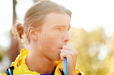 Buy stock photo Fitness, man and drinking water with hydration pack for health, wellness and exercise recovery on break. Outdoor, liquid and thirsty athlete at park with tube system for nutrition or electrolytes