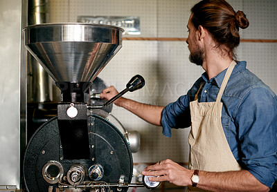 Buy stock photo Cafe, entrepreneur and man with machine, roasting and process for fresh coffee, retail and morning. Small business, grinder and person with equipment for tea, hospitality or productivity for beverage