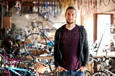 Buy stock photo Man, portrait and handyman in bicycle repair shop for maintenance, confidence and garage. Bike, mechanic and service with a professional technician for startup, small business and workshop for fixing