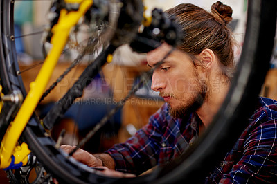 Buy stock photo Mechanic, workshop and man with bicycle tyre for repair, fixing and bike maintenance with tools. Small business, technician and person with equipment for wheel, gears and cycling service in garage