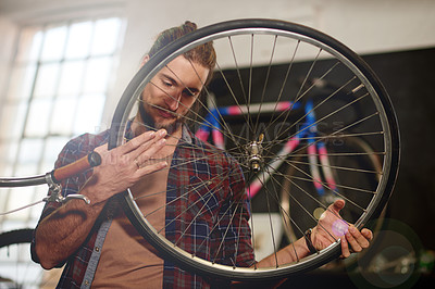 Buy stock photo Man, repair or tyre inspection with bicycle for maintenance or fix in workshop or garage. Male person, bike mechanic or cycle technician with wheel for air pressure, mend or replacement service