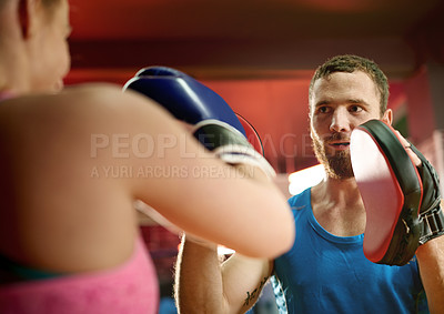 Buy stock photo Pad, sports or woman with coach for boxing exercise, strong punch or self defense gym. Class, people or boxer in practice for teaching technique, learning or fitness workout with fighting trainer