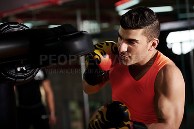 Buy stock photo Boxing, pad and man with fitness punch at gym for fight training, sparring or improve coordination. Workout, technique and professional boxer in health club for conditioning, performance or endurance