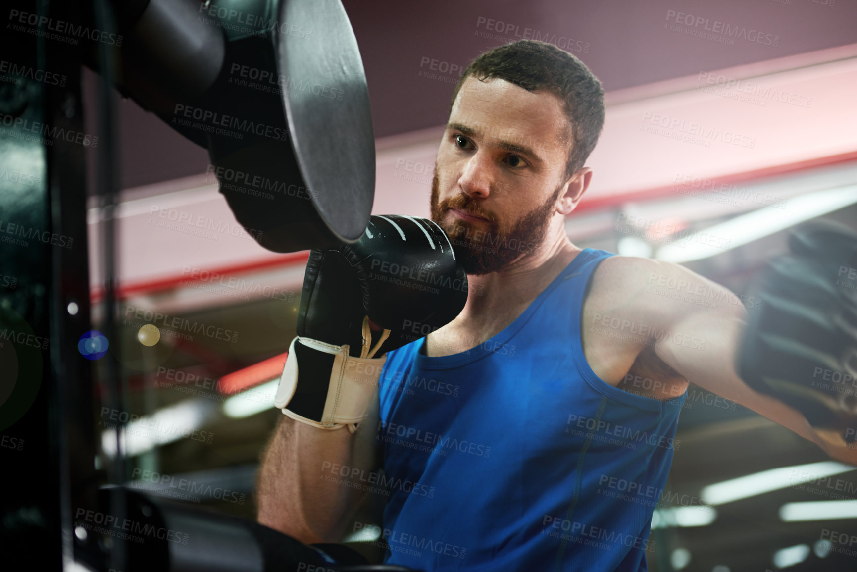 Buy stock photo Punch, sports or man with pads for boxing exercise, strong impact or self defense gym. Fist, athlete and boxer in practice for training technique, learning and fitness workout with fighting skills