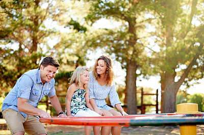 Buy stock photo Smile, parents and child carousel at playground for holiday fun, playing games and bonding together. Happy, family or kid on merry go round for spinning ride, activity and balance support on vacation