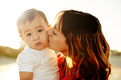Buy stock photo Mom, baby and kiss outdoor for love, bonding and affection for family travel with sunshine. Portrait, boy kid and woman with single parent, vacation or adventure with moment together in nature