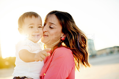 Buy stock photo Mother, baby and hug outdoor with flare, bonding and affection for family travel with sunshine. Love, boy kid and woman with single parent, vacation and sunset adventure for happy moment in nature