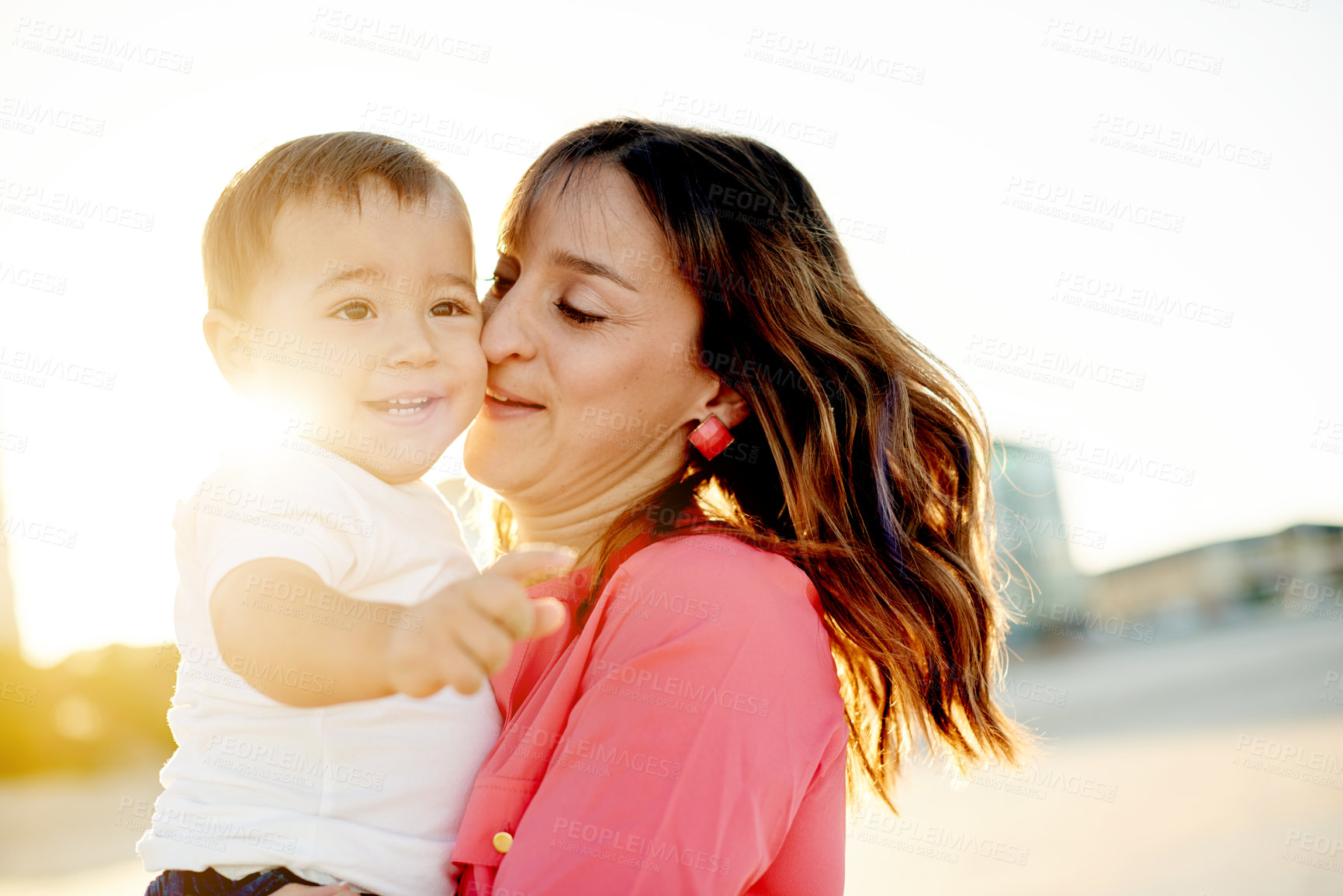 Buy stock photo Mother, baby and hug outdoor with flare, bonding and affection for family travel with sunshine. Love, boy kid and woman with single parent, vacation and sunset adventure for happy moment in nature