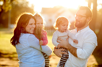 Buy stock photo Happy family, outdoor and sunlight in park, hug and care for love connection. Smile, parents and young children in summer outing trip with bonding, support and trust for special memory together.