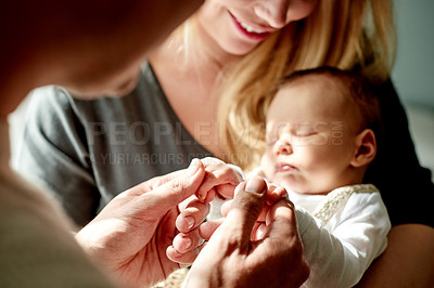 Buy stock photo Happy, holding hands and parents with baby in home with calm, care and love in family time. Bonding, smile and newborn sleeping with mother and father for support, comfort or trust together in house.
