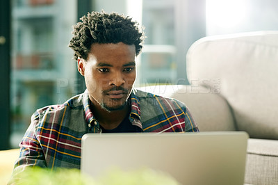 Buy stock photo Laptop, research and black man in home for remote work,  freelance and creative project in living room. Email, computer and African male copywriter with online article for publishing in apartment.