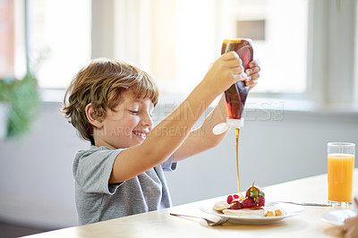 Buy stock photo Breakfast, child and pancakes in home with syrup, meal prep and excited for eating. Happiness, boy and fruit in kitchen with food, snack and hungry in morning for growth and development in childhood
