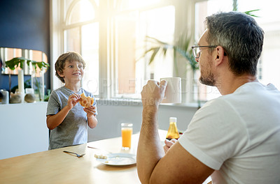 Buy stock photo Home, breakfast and father with boy, love and bonding together with nutrition, smile and coffee. Family, apartment and dad with happy son, morning food and parent with kid, healthy meal and eating