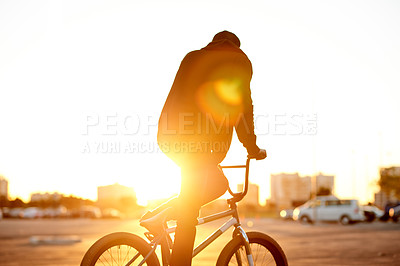 Buy stock photo Sunset, training and man on bicycle in city for journey, fun or skills activity with action. Adrenaline, adventure and person on bike practicing for competition, challenge or race in urban town.