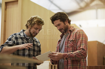 Buy stock photo Carpenter, collaboration and men with tablet for discussion, inventory and furniture manufacturing. Carpentry, team and tech in workshop for production, planning project or check stock for woodwork