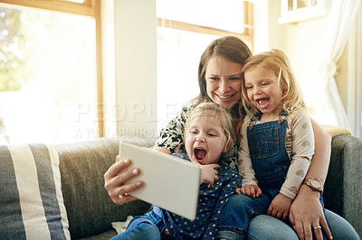 Buy stock photo Mother, children and tablet on sofa with laugh, love and together for video, cartoons and relax in home. Woman, girls and digital tech for social media, games or movies in living room in family house