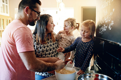 Buy stock photo Baking, help and bowl with family in kitchen for support, cooking and learning dessert recipe. Teaching, bonding and food with parents and children in home for cupcake, love and growth together