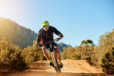 Buy stock photo Cycling, helmet and speed with man in mountains for outdoor exercise, fitness or hobby. Bike, off road trail and sunglasses with cyclist person in nature for challenge, performance or sports training