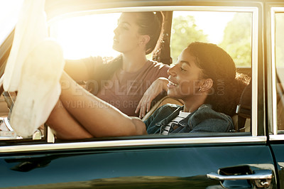 Buy stock photo Women, friends and road trip with feet, window and relax with view, sightseeing and excited for holiday. Girl, smile and travel on vacation with flare, memory or vehicle on transport on journey