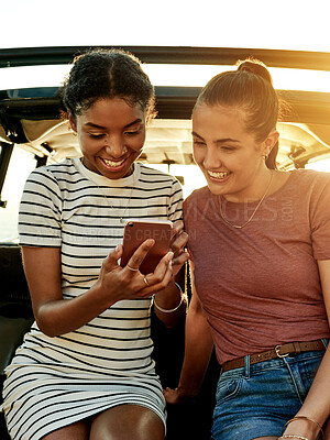 Buy stock photo Happy women, friends or car with phone for road trip, social media or past memory together. Female people, smile or scrolling with mobile smartphone for travel, capture moment or nostalgia in vehicle