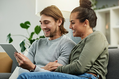 Buy stock photo Couple, laugh and relax with tablet, home or bonding with entertainment, watching movies and online. Happy, woman and date with man in living room, subscription and tech for comedy film in house