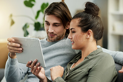 Buy stock photo Bonding, couple and watching movies on tablet, lounge and happy with entertainment, online and home. Relax, woman and smile with man in living room, subscription and tech with film for date in house