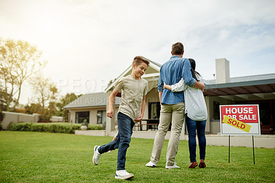 Buy stock photo Relocation, real estate and new home for family, hug and milestone for homeowner with property and yard. Outdoor, sold sign and people with investment of house, playing and parents with child