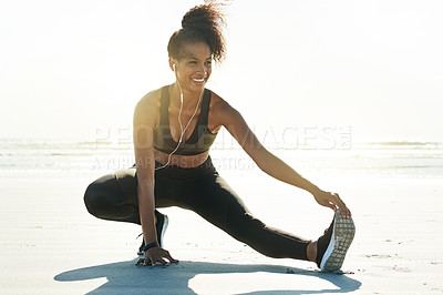 Buy stock photo Fitness, woman and leg stretching on beach with earphones to start running, workout or cardio album. Mockup space, runner and warm up on seashore for exercise preparation, muscle relief and podcast