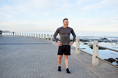 Buy stock photo Mature man, runner and break by ocean, promenade and smile with thinking, fitness and training in summer. Person, happy and outdoor by sea for workout, health and wellness with rest in Australia