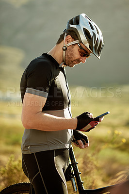 Buy stock photo Phone, reading and bike with man in nature for location app, cycling route and social media post. Speed performance tracking, contact and bicycle with person outdoor for fitness and direction search