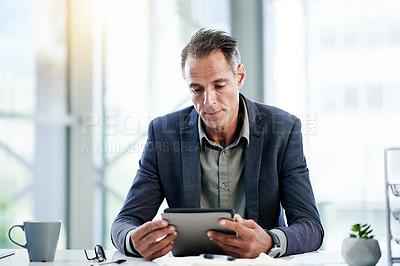 Buy stock photo Reading, news and businessman on tablet in office for online report, finance and audit. Account, review or mature banker on touchscreen in financial agency for equity, stock research and investment