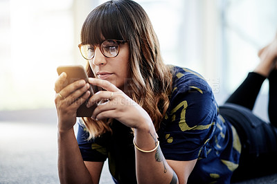 Buy stock photo Woman, phone and reading on floor with relax, social media and message in text. Female person, smartphone and communication in office for website, update and gossip conversation on contact app