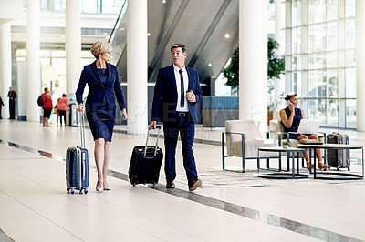 Buy stock photo Walking, travel and teamwork with business people in airport for conference trip, networking and suitcase. Partnership, international destination and commute with employees in lobby for discussion