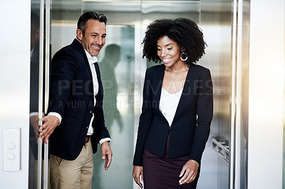 Buy stock photo Business, people and exit elevator in office for work arrival, enter building and employee courtesy. Woman, man and holding lift door for walking, leaving appointment and company floor with respect