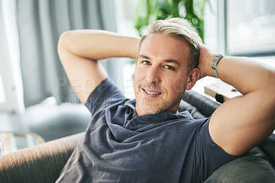 Buy stock photo Happy man, portrait and relief on sofa in home, pride and confidence with rest in living room. Person, relax and smile for break on couch, comfort and chill in lounge at apartment in Portugal