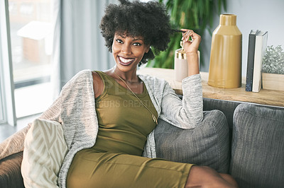 Buy stock photo Portrait, happiness and black woman in house, break or comfortable on weekend, calm and living room. Relax, person and rest on couch, smile or confident in home, peace or positive attitude in Nigeria