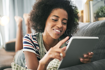 Buy stock photo Happy, home and black woman with tablet, online reading and message with social media, email and app. Smile, relax and African person on couch, technology and internet with connection or website info