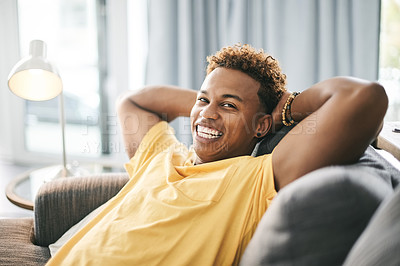 Buy stock photo Relax, laugh and portrait of black man on sofa for chilling, rest and comfortable on weekend. Happy, home and person laying on couch for break, calm and free time with smile, wellness and peaceful