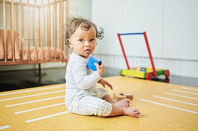 Buy stock photo Baby, floor and playing with toys in house for learning, childhood development or stimulation. Boy, infant kid and wood blocks on flooring for game, education or problem solving skills in family home