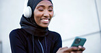 Music, fitness and muslim woman with mobile outdoor, listen to radio or audio break with smile. Hijab, happy runner and black person with phone, headphones and streaming song with podcast in city